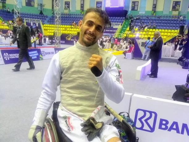 Ammar Ali - Iraq - Wheelchair fencing - Indonesia 2018 Asian Para Games A man in a wheelchair wearing a fencing uniform