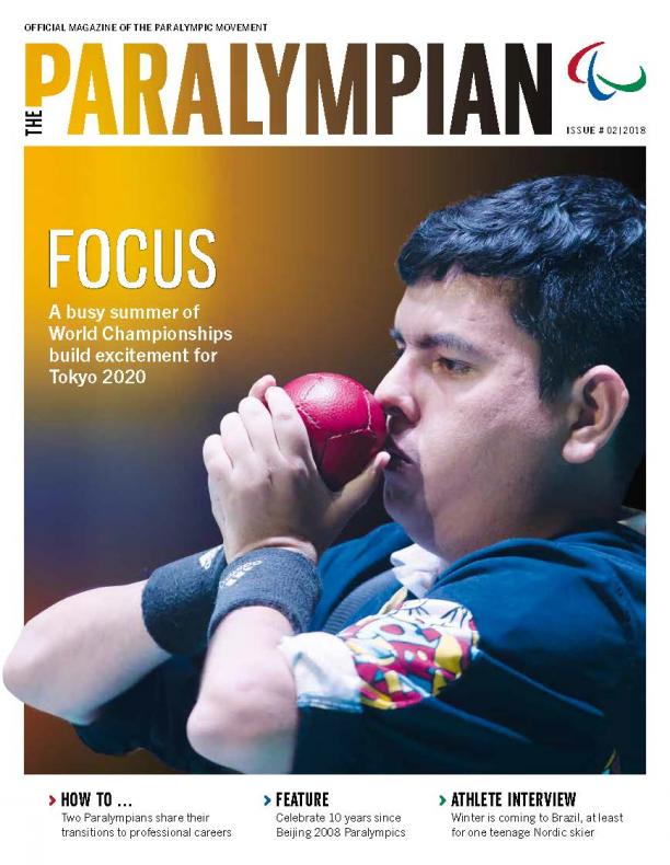 Magazine cover photo of Colombian athlete drawing a boccia ball to his face