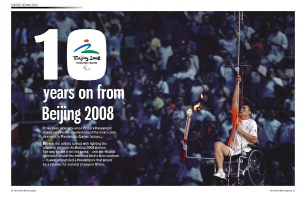Page of a magazine showing a man in wheelchair climbing a rope with the Paralympic couldron 