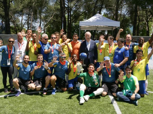 Brazil win world title - Madrid 2018 a group of male blind footballers wearing Brazil shirts and holding their hands up in celebration