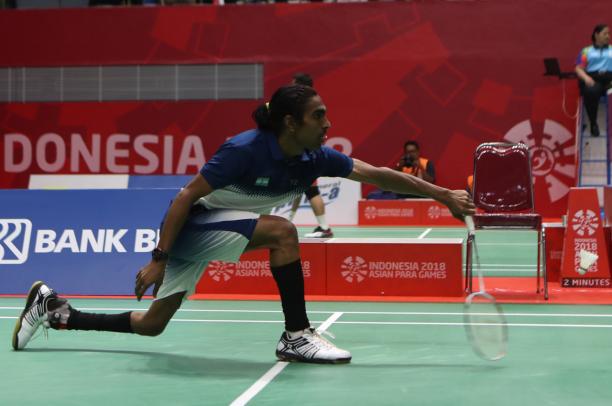 Pramod Bhagat - Indonesia 2018 male Para badminton player Pramod Bhagat lunges to play a backhand