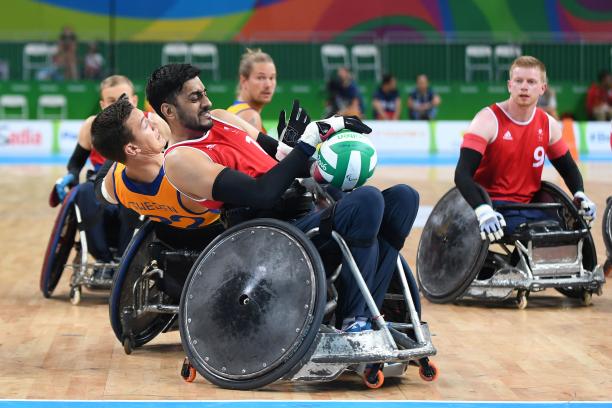 wheelchair rugby players grappling for the ball
