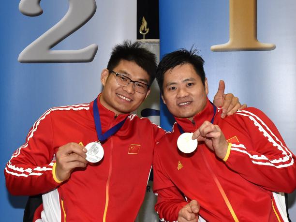 Hu Daoliang and Feng Yanke - Pisa 2019 male wheelchair fencers Hu Daoliang and Feng Yanke hold up their medals and smile