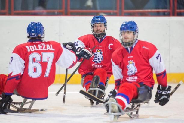 Three male Para ice hockey players on ice