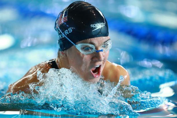 female Para swimmer Rebecca Meyers takes a breath mid-breaststroke