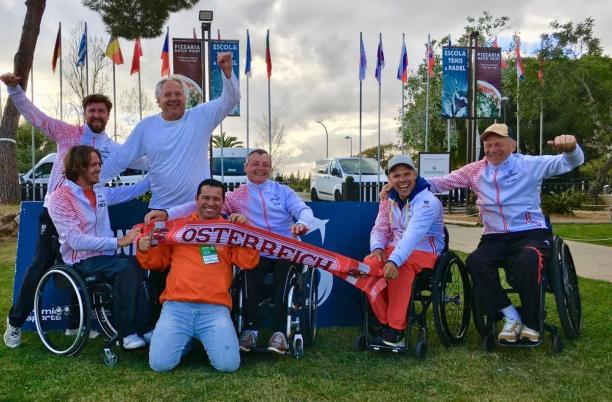male wheelchair tennis players from Austria holding up Austrian scarves and flags