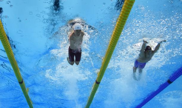 Lichao Wang - China - Rio 2016 Paralympic Games An armless man swimming next to a short stature man