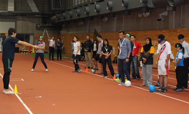 Agitos Foundation - Road to the Games project A group of people standing on a court blindfolded
