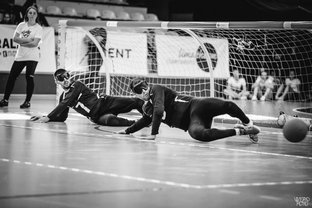 Greece men's goalball a team of male goalball players standing with their arms linked on a court