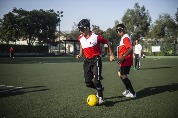 Blind football player wearing Peruvian shirt in posession of the ball