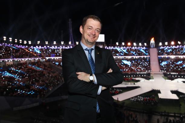 Andrew Parsons - IPC President IPC President Andrew Parsons smiles and crosses arms with the PyeongChang 2018 stadium in the background during the Closing Ceremony