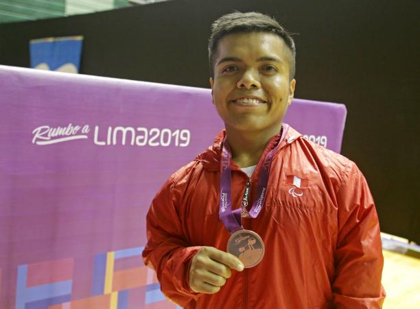 Diego Quispe - powerlifting - Lima 2019 Diego Quispe smiles while he holds the bronze medal he won at the Lima World Cup