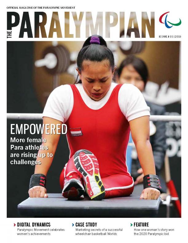 Magazine cover photo of Asian powerlifting bowing her head