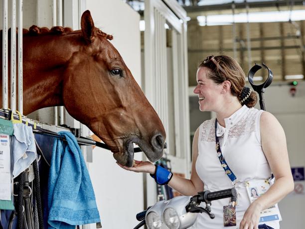 Sanne Voets female Para equestrian rider Sanne Voets feeding her horse