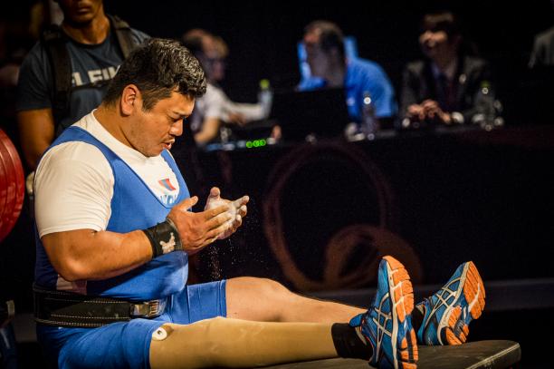 Sodnompiljee Enkhbayar - Mongolia - powerlifting Sodnompiljee Enkhbayar stares at his hands while sitting on the bench before a lift
