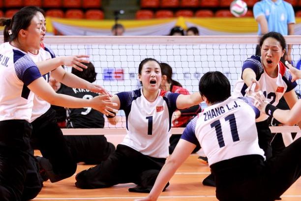 Chinese female sitting volleyball players celebrate a point