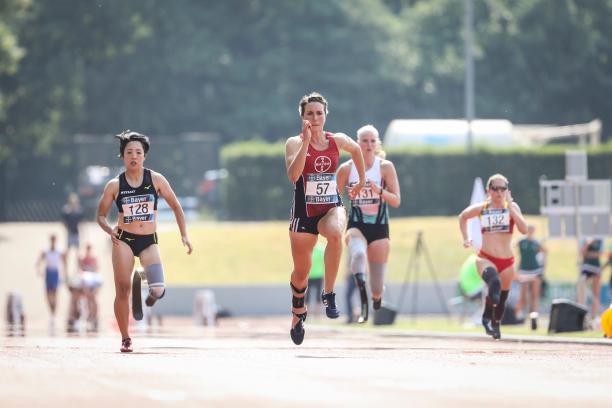 Four female Para athletes running in a track
