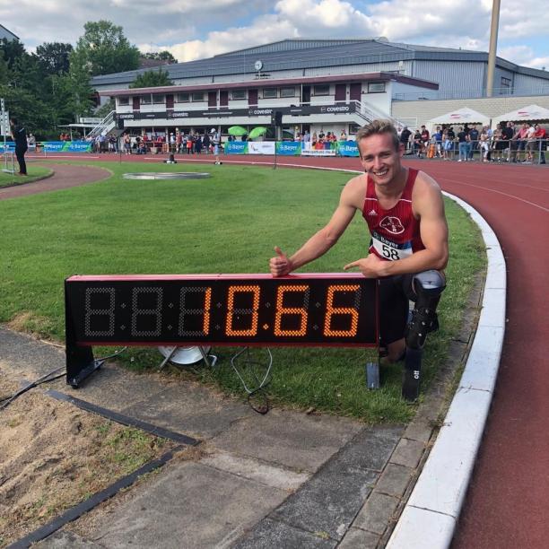 Johannes Floors - Germany - athletics German male sprinter poses next to a clock that says 10.66