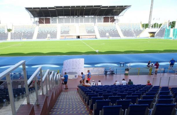 A stadium with a blue athletics track
