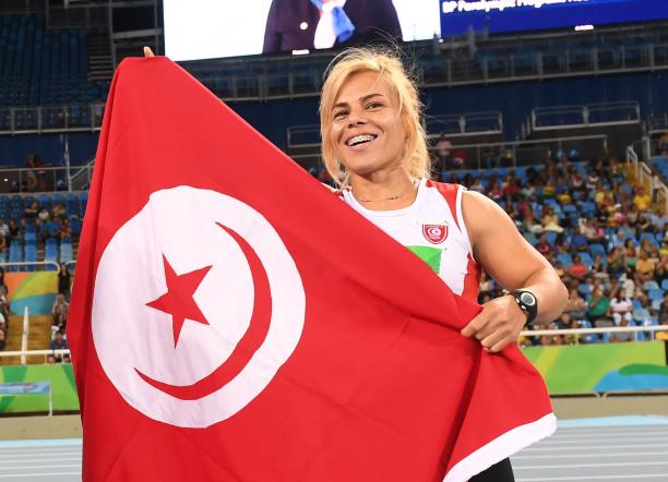 Raoua Tlili - Rio 2016 female Para athlete Raoua Tlili holds up the Turkish flag and smiles