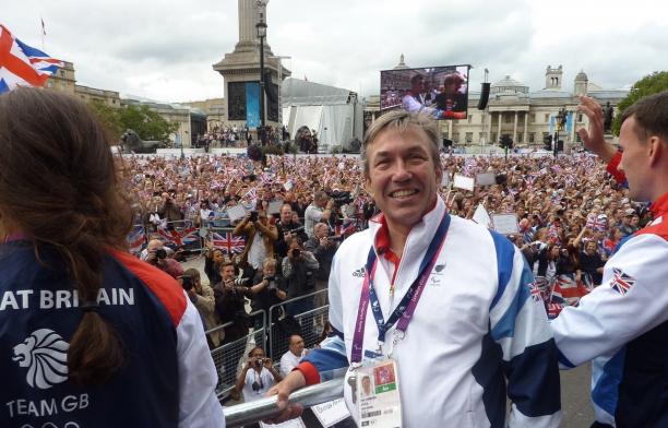 Nick Webborn - Great Britain - VISTA British man in wheelchair smiling in front of a big crowd of people