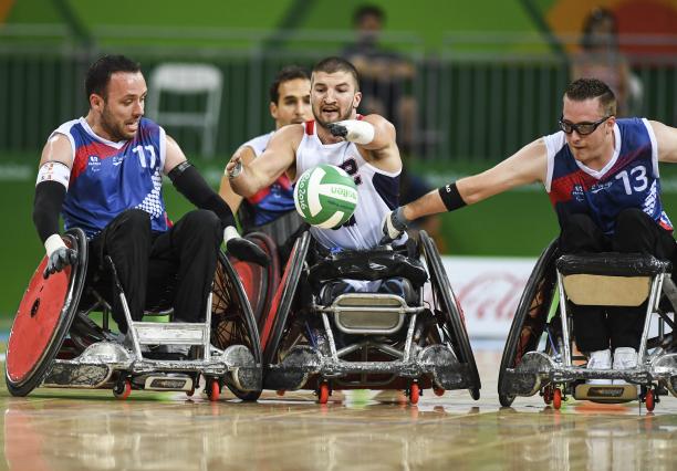 Kory Puderbaugh of United States and Christophe Salegui and Jonathan Hivernat of France compete during the Wheelchair Rugby match between United States and France
