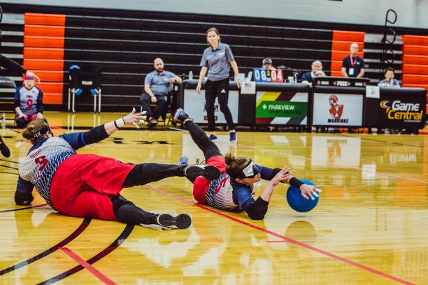 USA goalball A female goalballer slides to block the ball from entering the goal