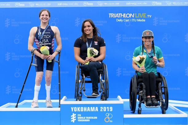Kendall Gretsch - Jade Hall - Lauren Parker - triathlon Three female triathletes on a podium smiling