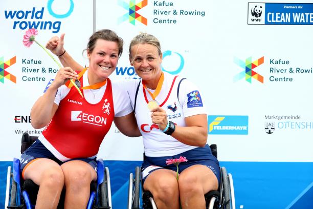 Annika Van Der Meer and Perle Bouge - World Cup II two female Para rowers in wheelchairs side hug on the podium