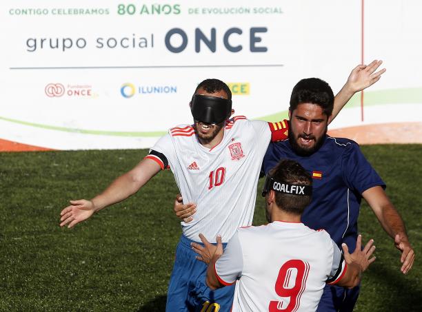 Spain blind football - Madrid 2018 three male blind footballers including two from Spain battle for the ball