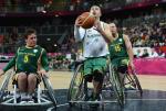 A picture of a man in a wheelchair playing basketball.