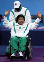 A picture of a woman in a wheelchair celebrating her victory
