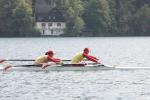 A picture of 2 chinese people rowing