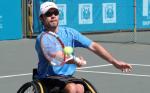 A picture of a man in a wheelchair playing tennis
