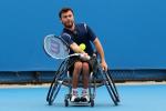 A picture of a man in a wheelchair playing tennis.