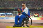 A picture of a man in a wheelchair during a medal ceremony