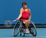 A picture of a woman in wheelchair playing tennis