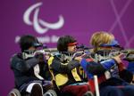 Yoojeong Lee of the Republic of Korea (R) shoots during the Women's R8-50m Rifle 3 Positions-SH1 final at the London 2012 Paralympic Games