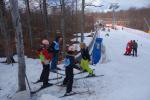 A group of youngsters are taught how to ski