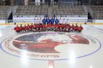 Ice sledge hockey players and coaches have a team photo