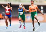blindfolded runner with guide and another female runner crossing a finish line