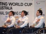 Three men in wheelchairs, having their hand on their chest