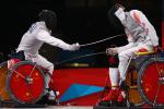 Ruyi Ye (L) of China on his way to winning gold against Yijun Chen (R) of China during the men's individual foil category A final of the wheelchair fencing at the London 2012 Paralympic Games.