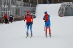 Two cross-country skier in blue competition clothes on the slopes