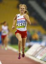 a Polish female running wearing red and white clothes