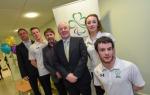 Six people pose in front of Paralympics Ireland banner