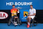 Wheelchair tennis player lifts the Australian Open trophy