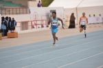 Man running on a blue track