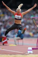 Woman with two blades doing long jump
