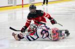 Two Para ice hockey players battle for the puck